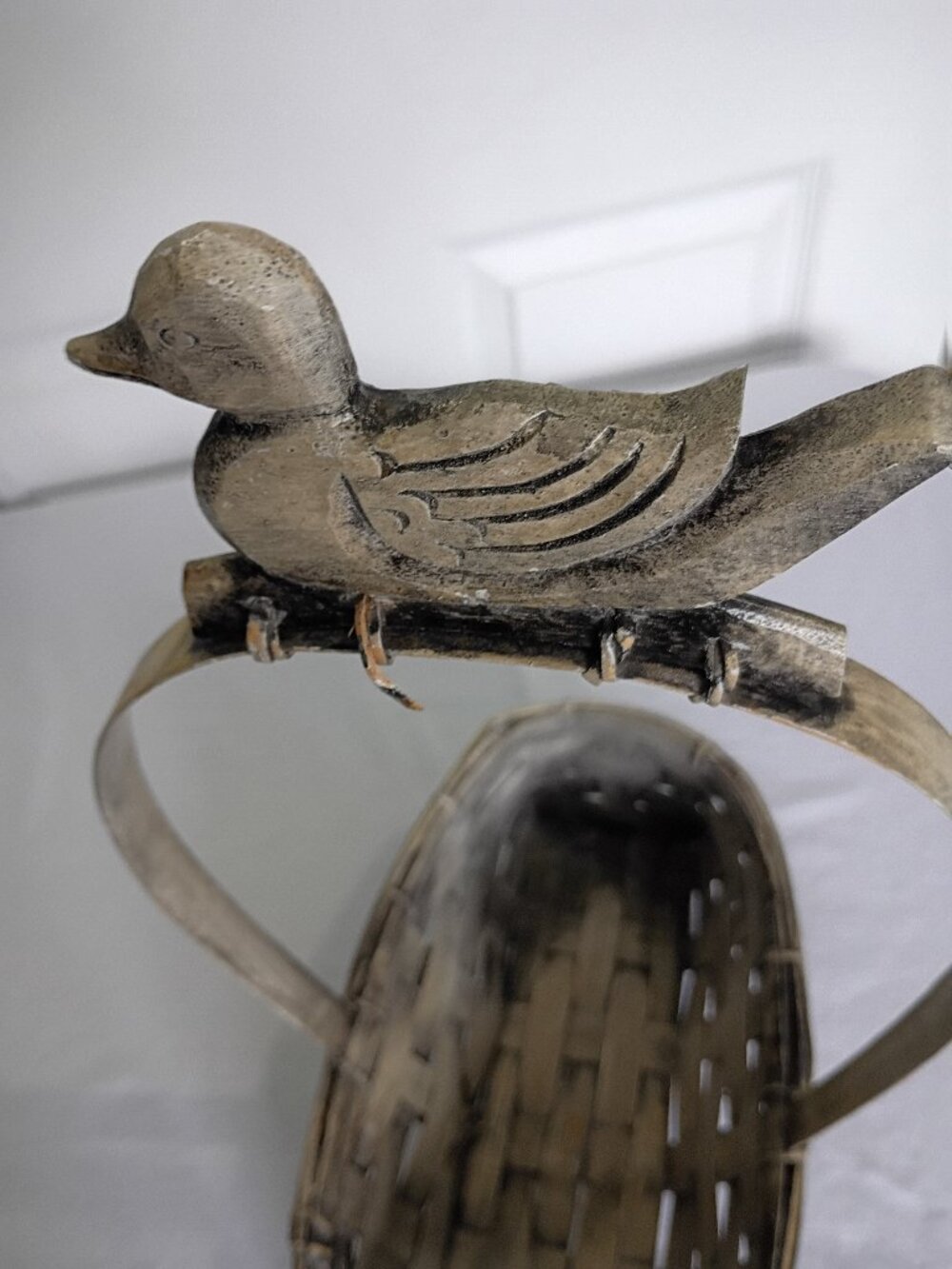 Vintage-Style Woven Basket with Decorative Wooden Duck.